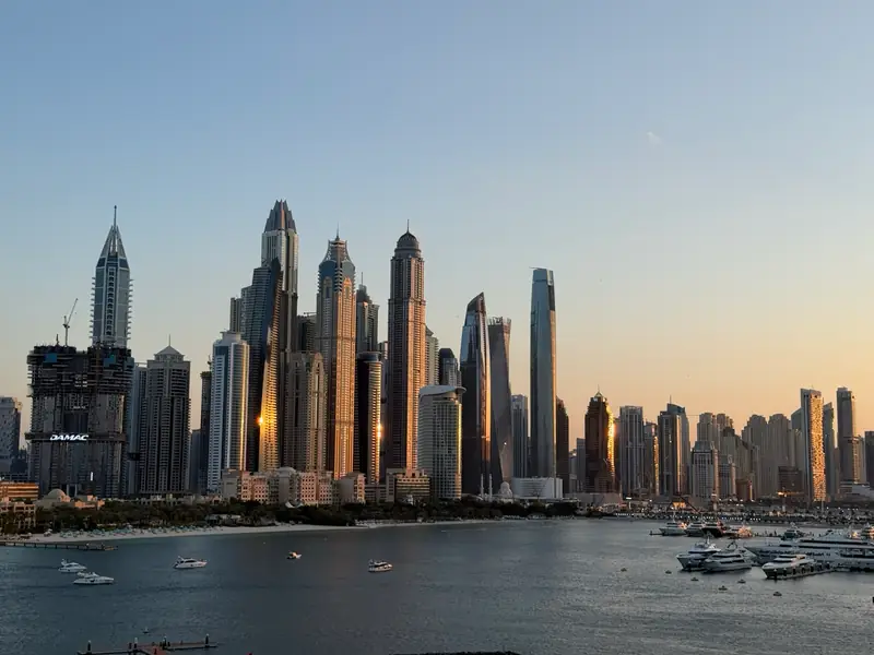 Dubai Marina towers at sunset above the water