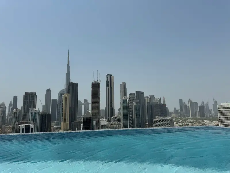 An infinity pool looking across the Dubai skyline to the Burj Khalifa