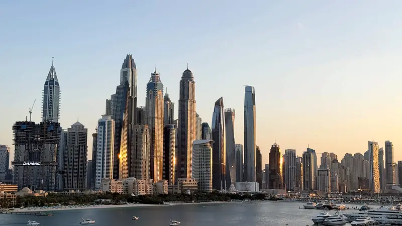 Dubai Marina towers glowing in golden hour light over the water