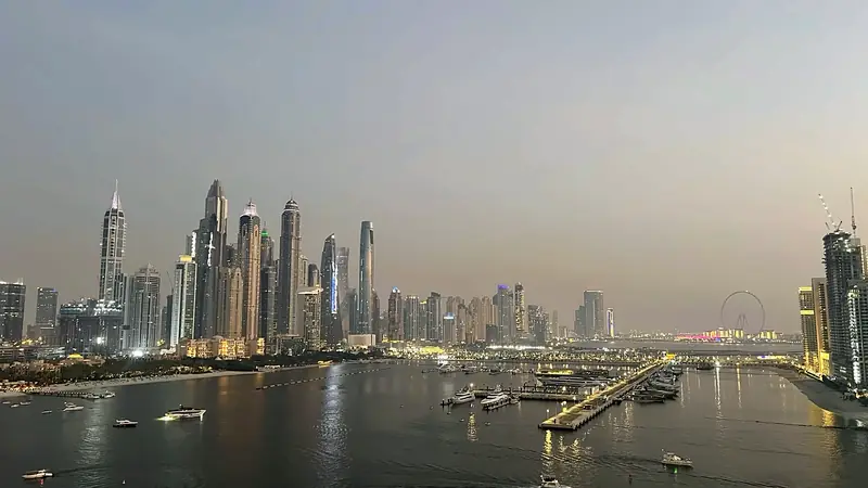 Dubai Marina and the bay at dusk with boats on the water